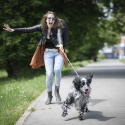 Young lady pulled by her dog. Dog walking tips, concept.